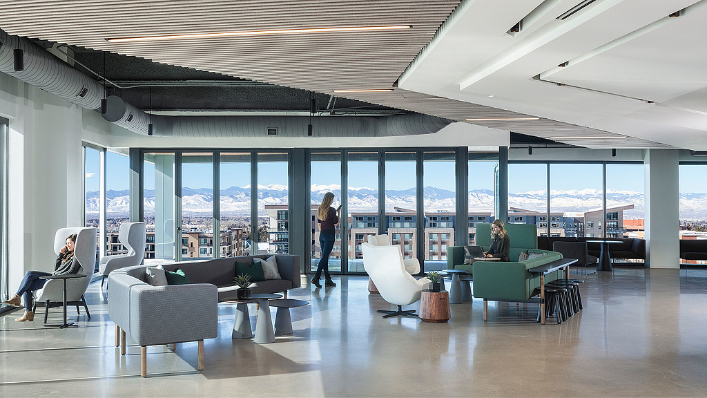 A room with a large window and a group of people in it.