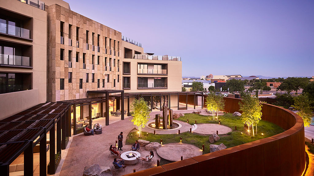 A courtyard with a building in the background.