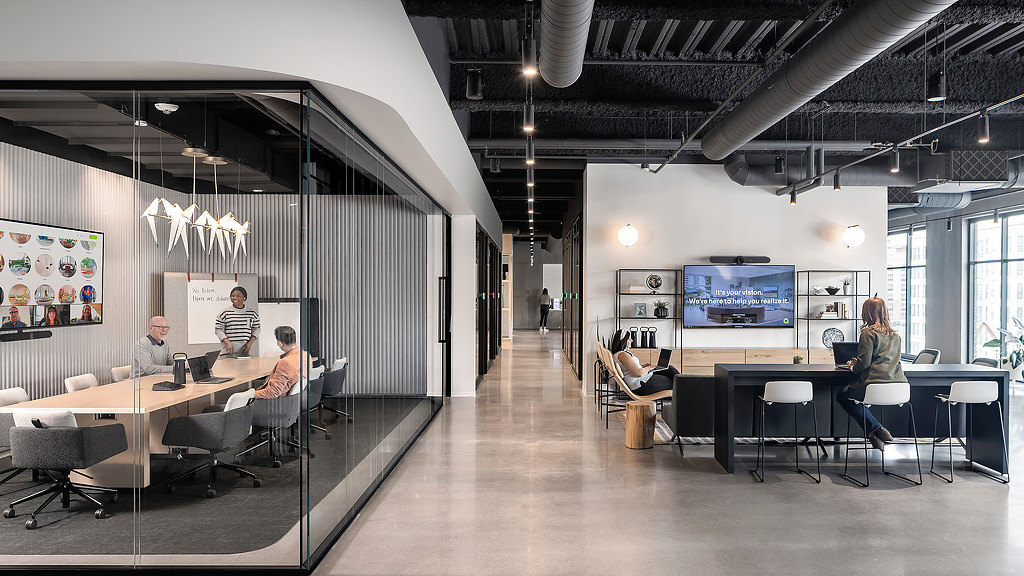 A modern office with a glass walled conference room and reception area at Acre Showroom