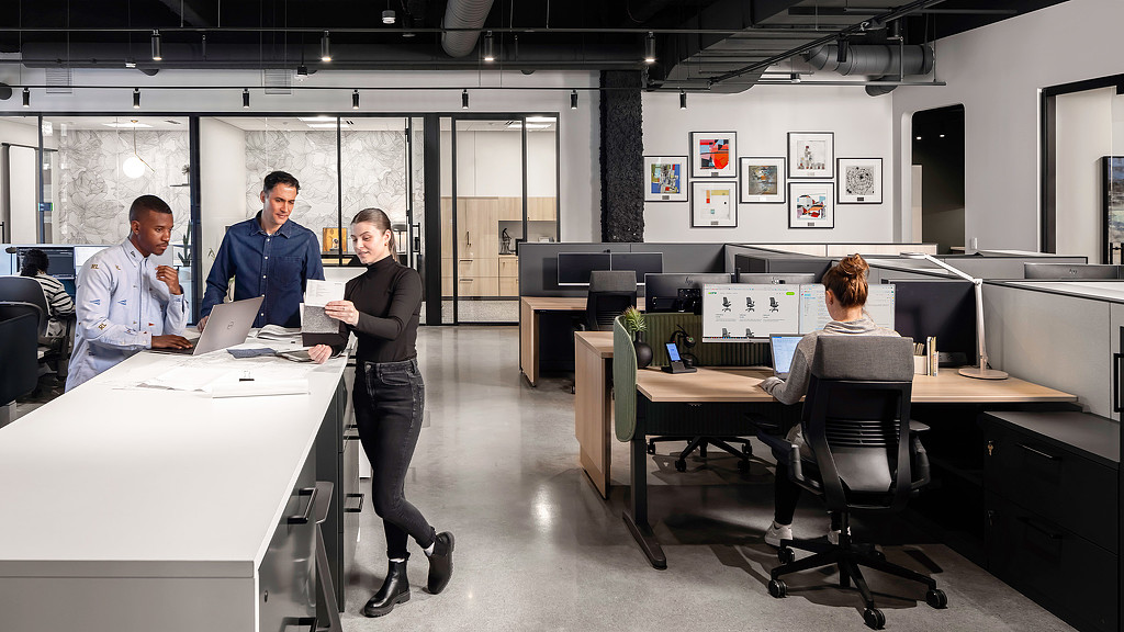 Modern office space at Acre Showroom with glass walls and open seating desks