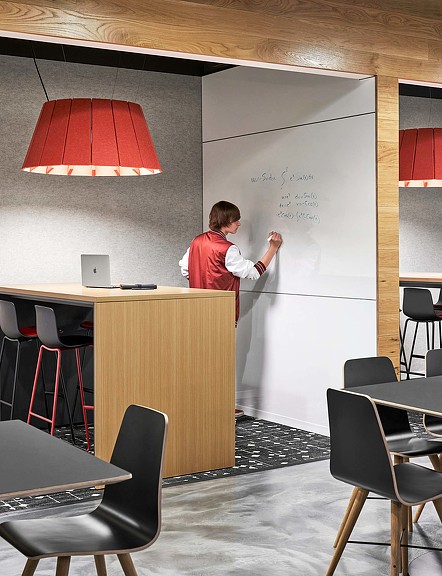 A workstation with a wall white board and person working at Kentucky University Commons Helm Library