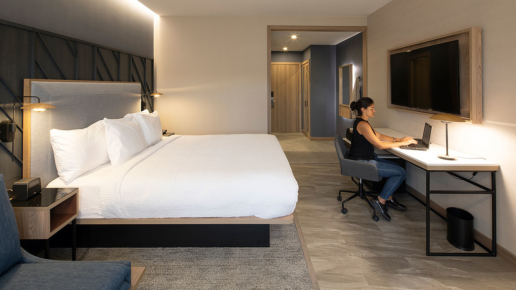 Woman on laptop in Marriott Courtyard San Jose room