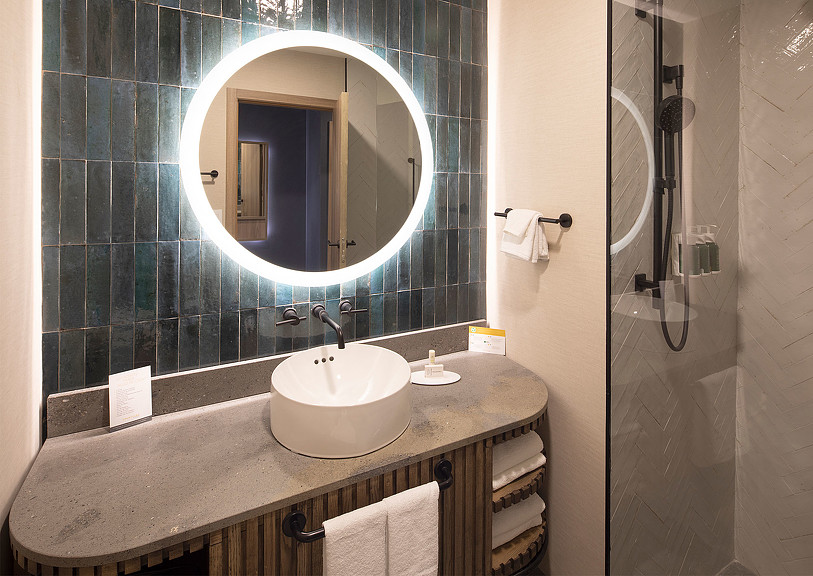 Marriott Courtyard San Jose bathroom with a round mirror