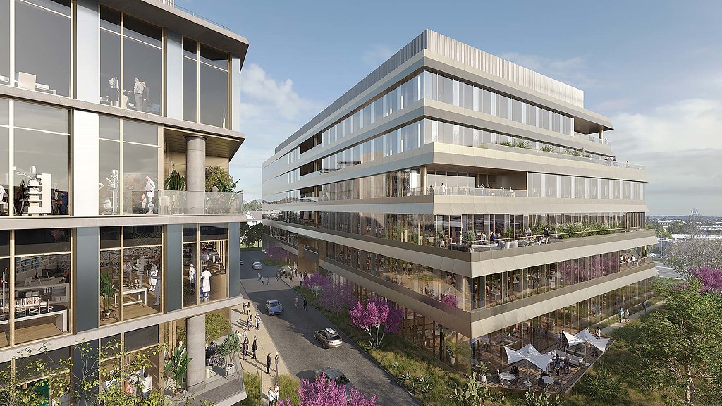 A building with a courtyard and cars.