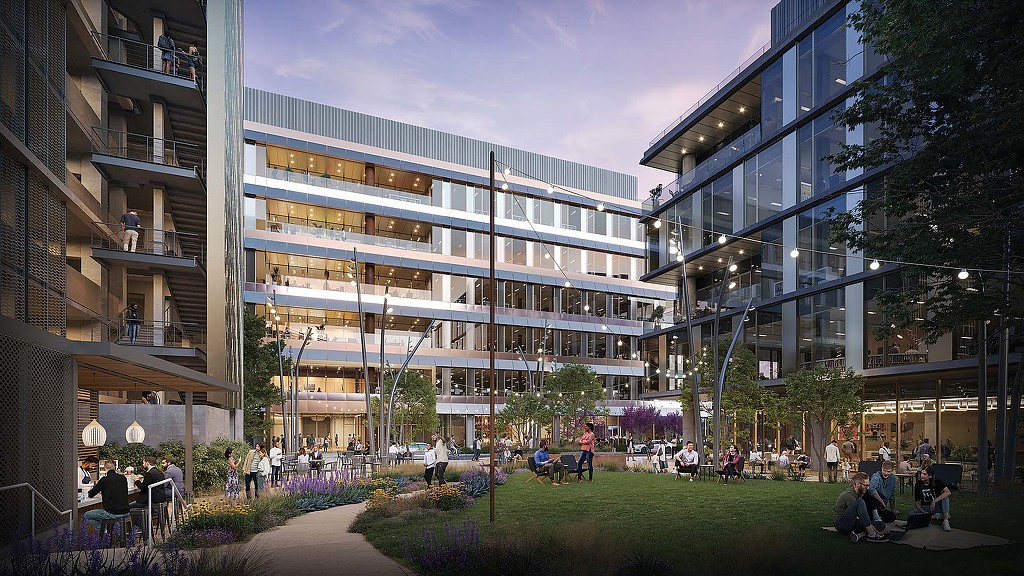 A group of people sitting outside of a building.