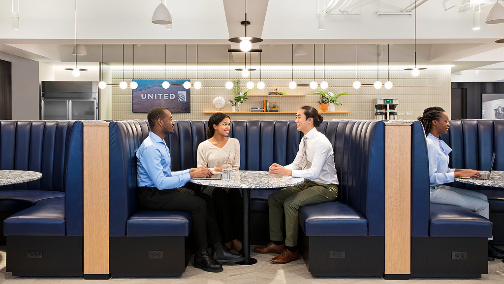 A group of people sitting around a table.