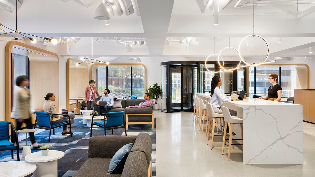 A waterfall marble countertop cafe area and seating at United Airlines lounge