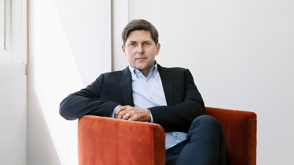 Benjy Ward from Gensler Chicago sitting in a burnt orange chair