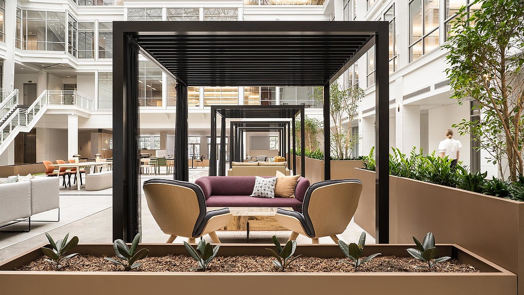 A patio with a couch and chairs.