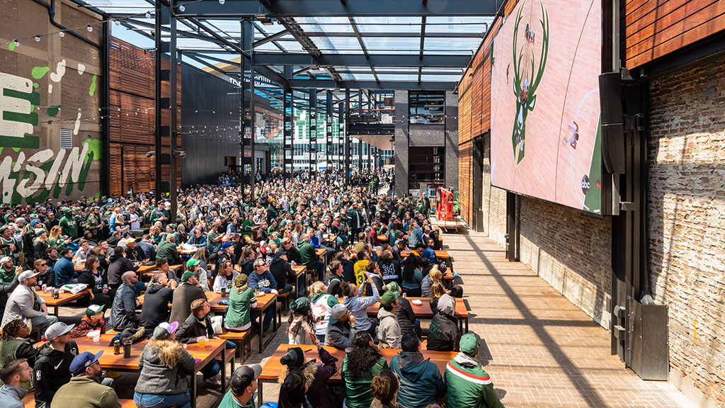 A large group of people sitting at tables in a large room.