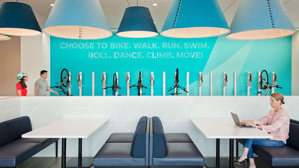 A person sitting at a table with a laptop.