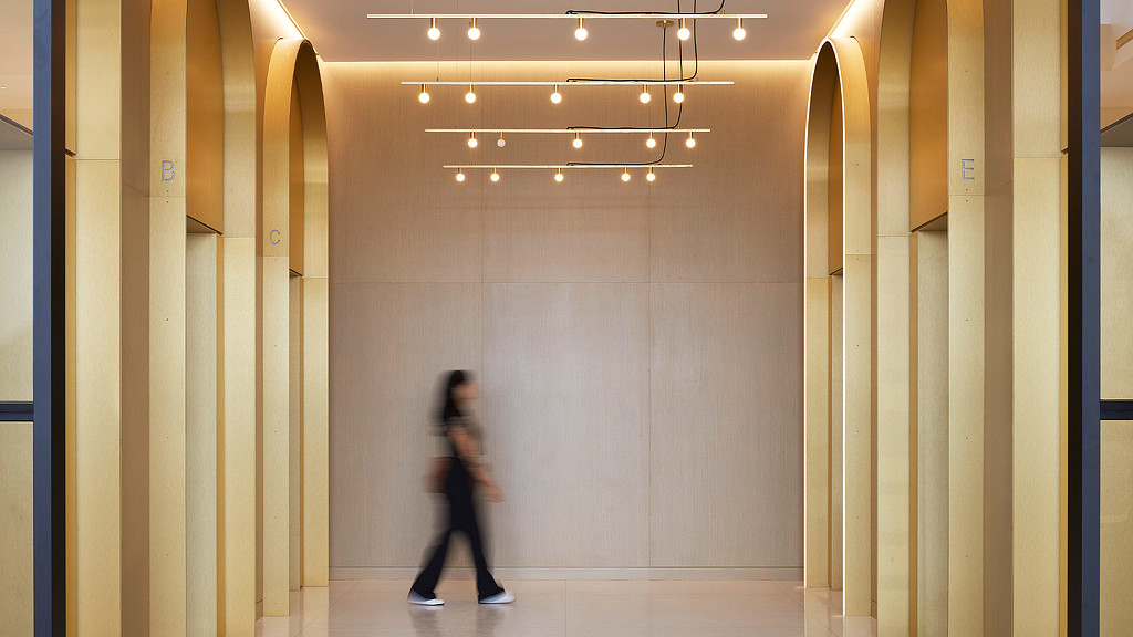 A person walking in a hallway in an elevator lobby at 1229 W Concord
