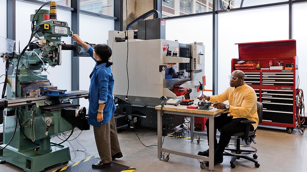 A man and a woman working in a factory.