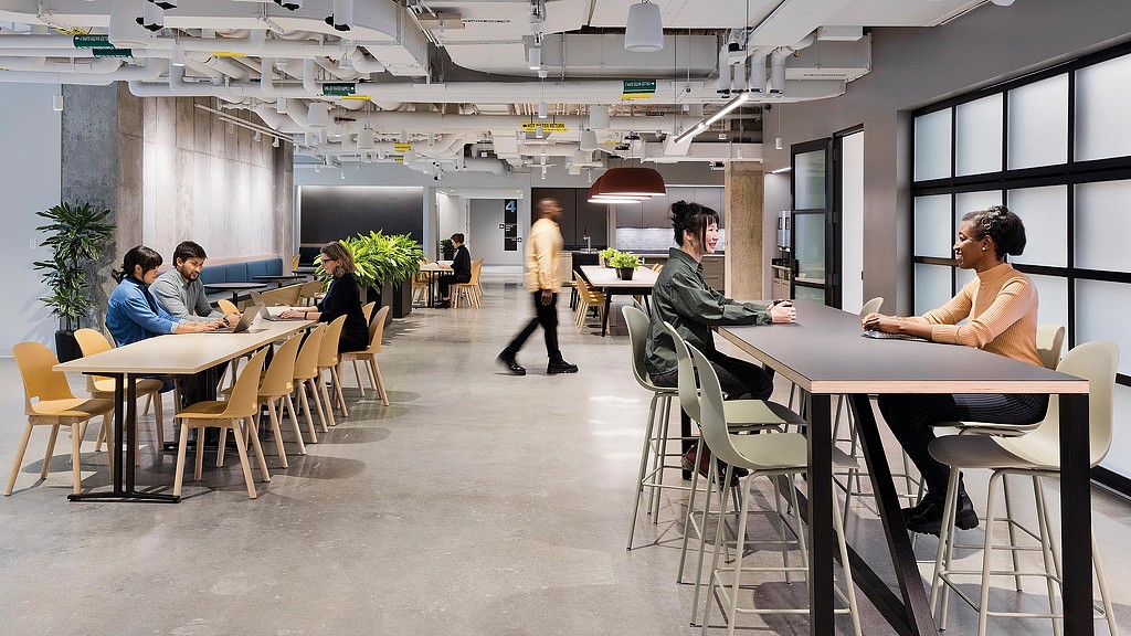 A group of people sitting at tables.
