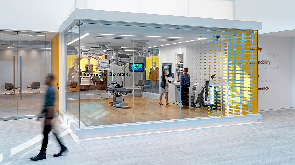 People in a room with a large endoscopy equipment