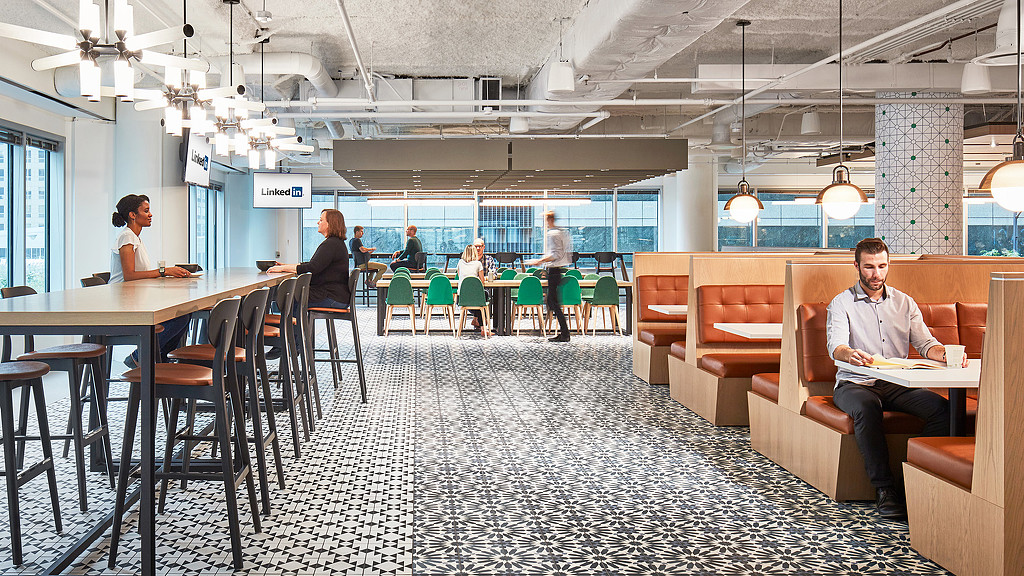 People sitting at tables in a restaurant cafe amenity space