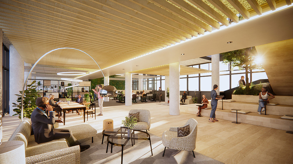 A group of people in a large room with tables and chairs.