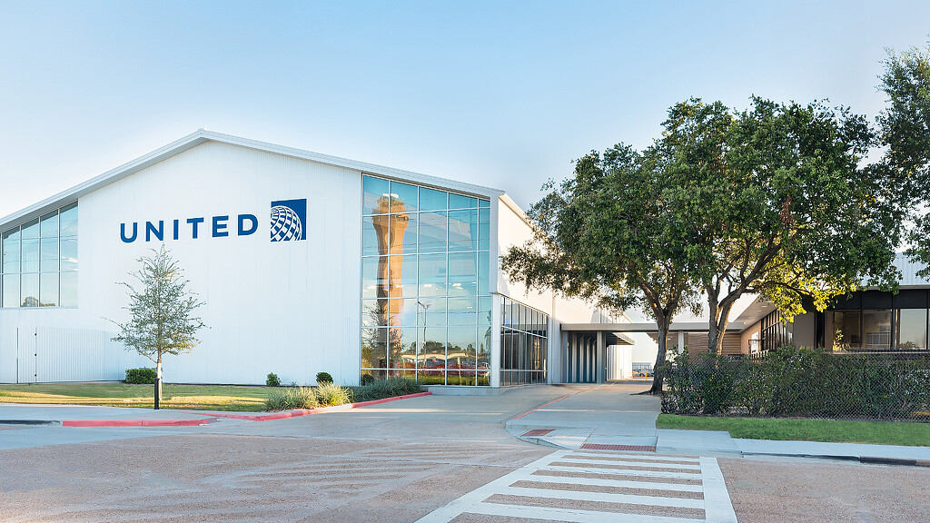 A building with a tree in front.