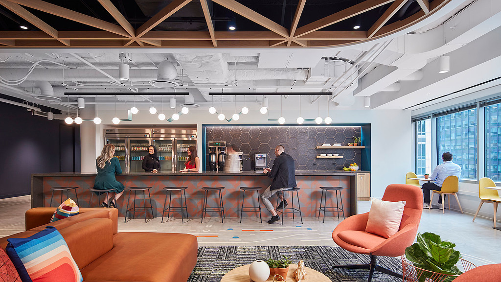 A group of people in a room with a cafe bar