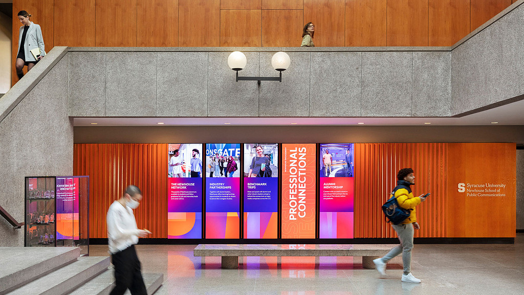Syracuse University hallway with digital screens