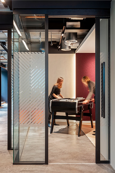 2 women playing foosball in a workplace amenity room