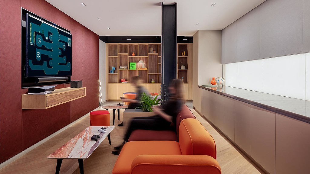 2 workers playing video game in workplace lounge