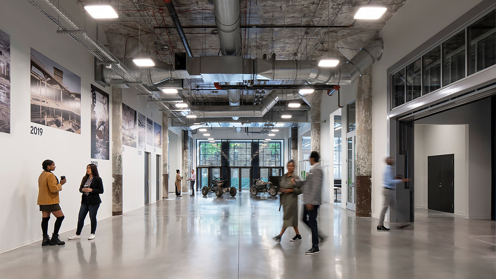 People walking in a large hallway at the book depository in Detroit, MI