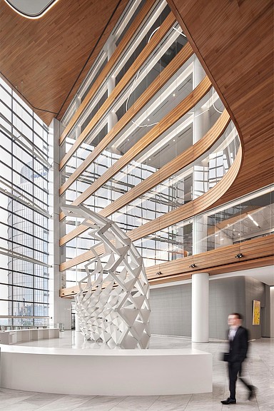 Man walking through Capital One McLean Block A lobby with white sculpture