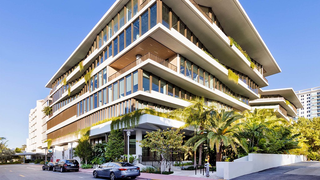 A building with cars parked in front.