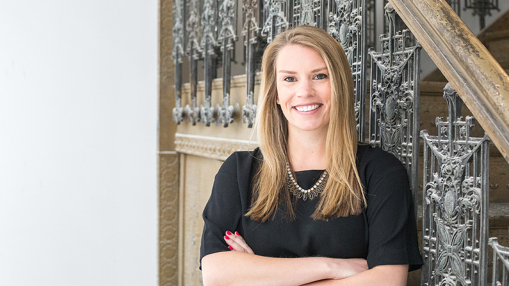 Kristin Oleson of the Gensler Chicago office in front of an ironwork staircase