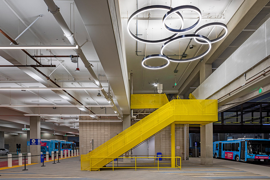 Economy Parking Garage with yellow stairs and circle light fixtures