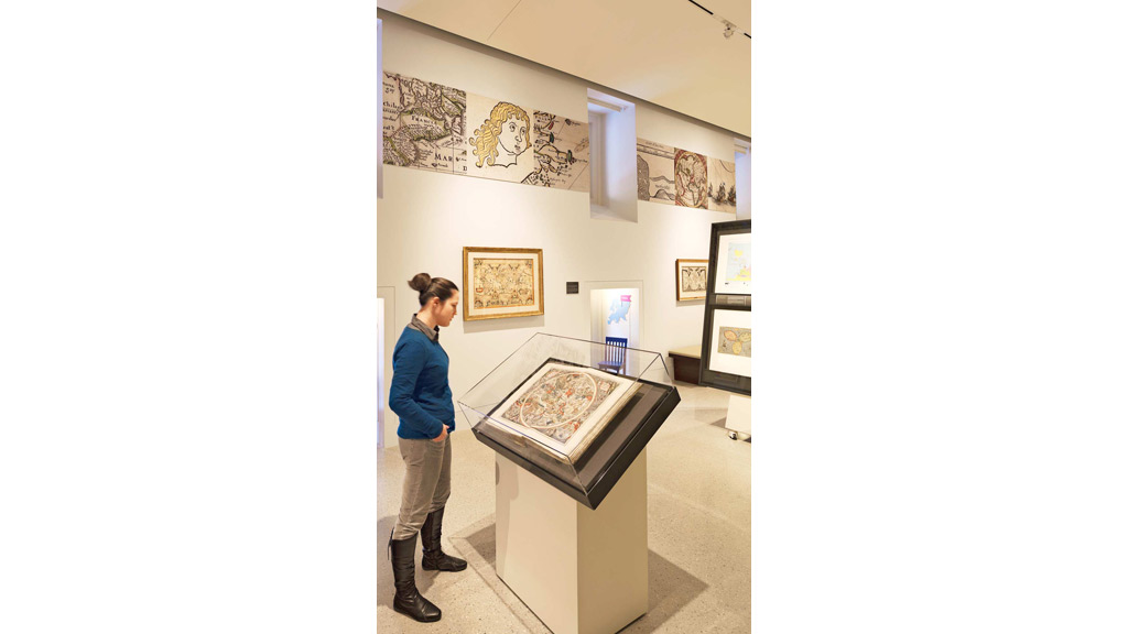 A person looking at art on the wall.