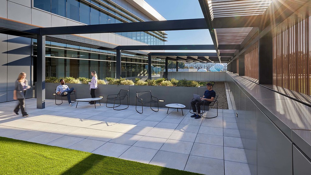 A group of people sitting outside a building.