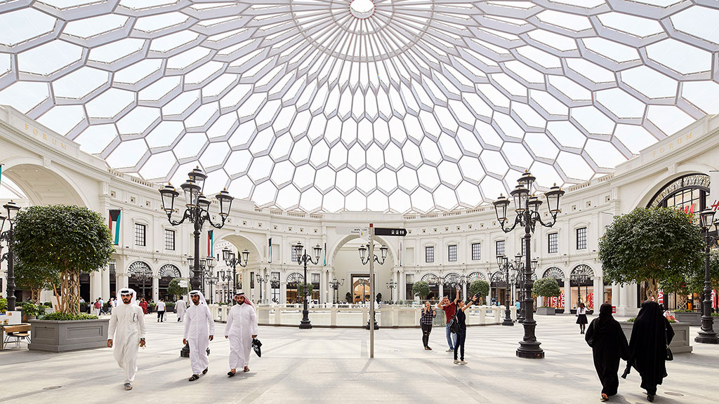 A group of people walking in a large building.