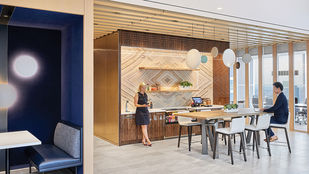 A man and a woman in a room with balloons.