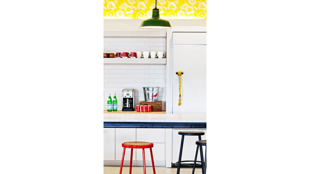 A kitchen with a white wall.