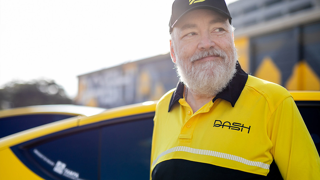 A close-up of man wearing Dash branded clothing