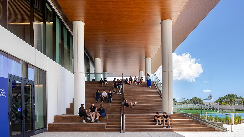 A group of people sitting on stairs.