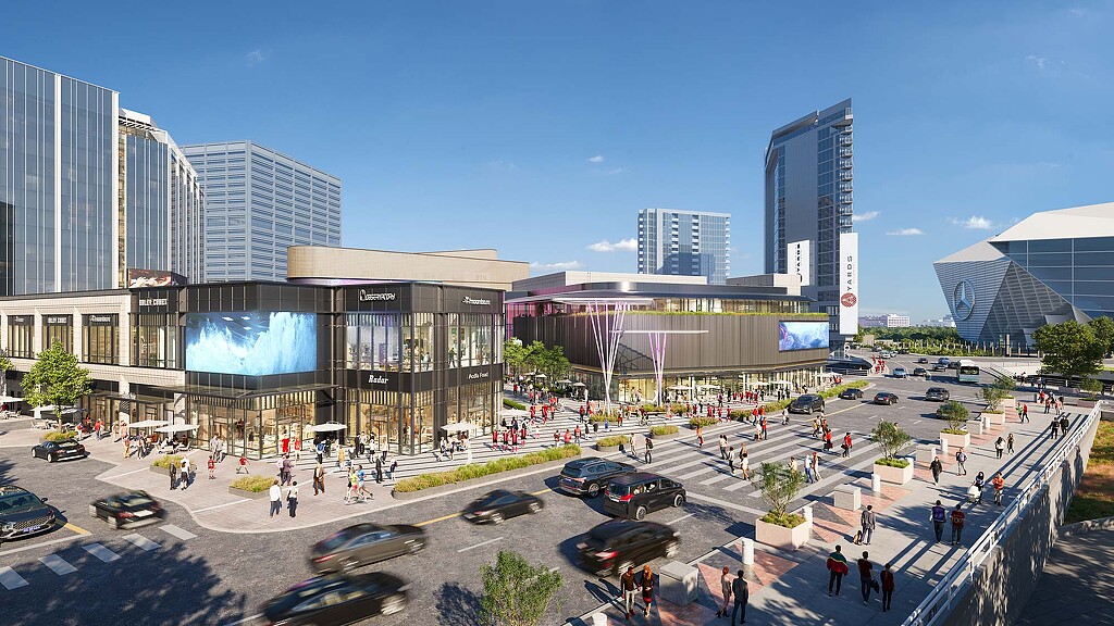 A large city square with a large building and a parking lot.