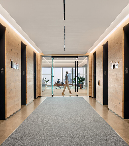 A man and a woman walking through a hallway.