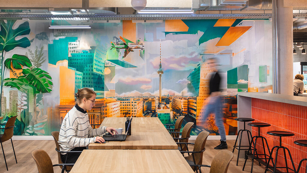 KAYAK Booking Holdings Berlin office cafe with colorful wall art