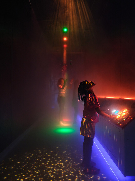 A person standing next to a traffic light.