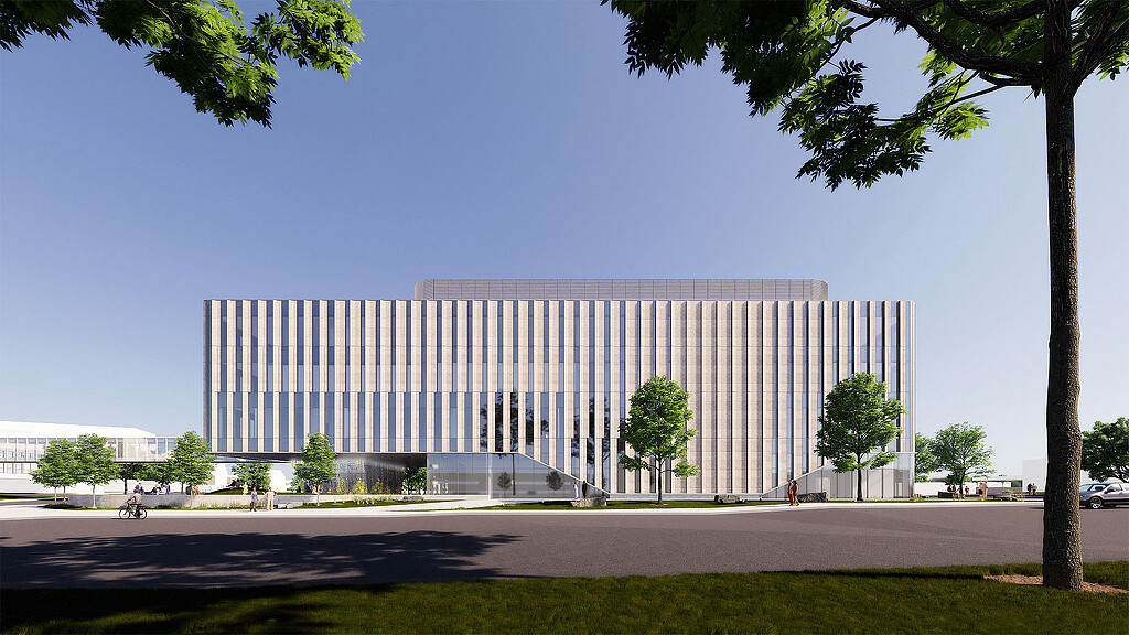 A large white building with trees in front of it.