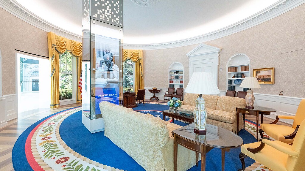 A living room with a large rug.