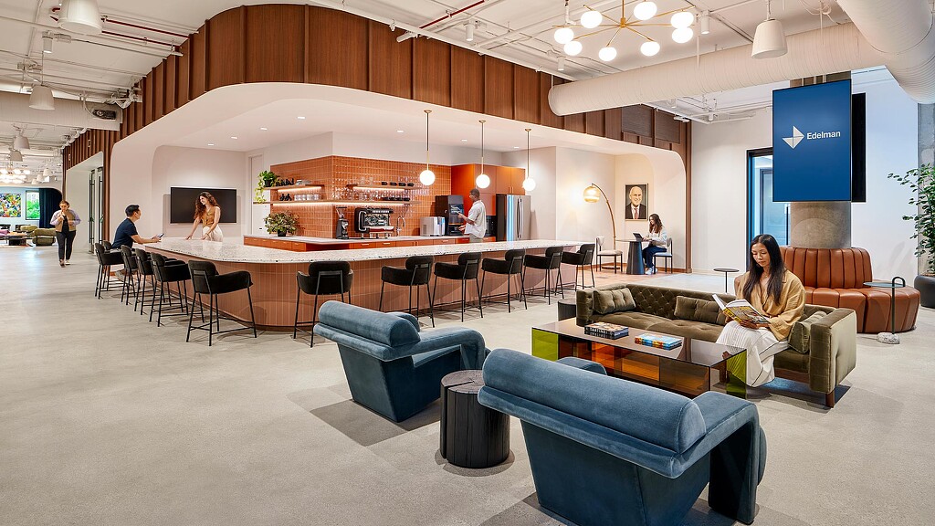 Edelman LA - A group of people sitting in a room with a large table and chairs.
