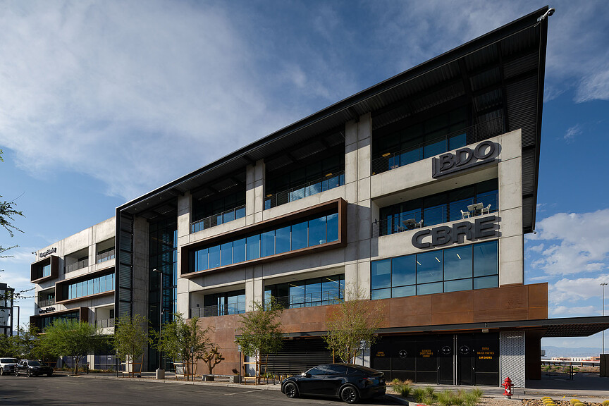 A building with cars parked in front.