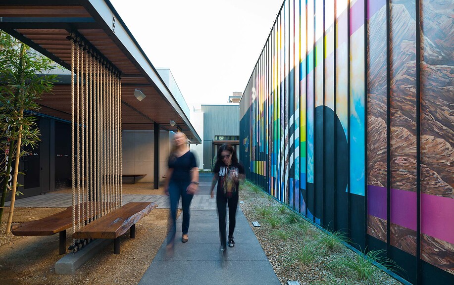 Two people walking along UnCommons outdoor walkway
