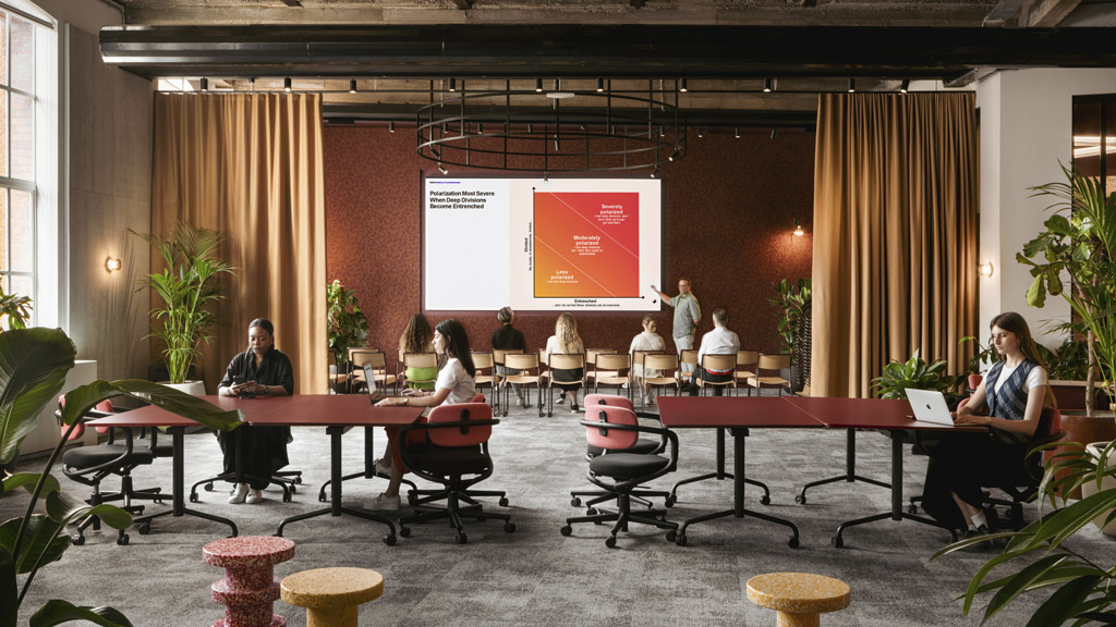 A group of people sitting in a room with a projector screen.
