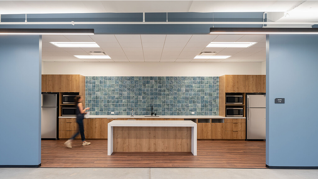 A person walking in a kitchen.