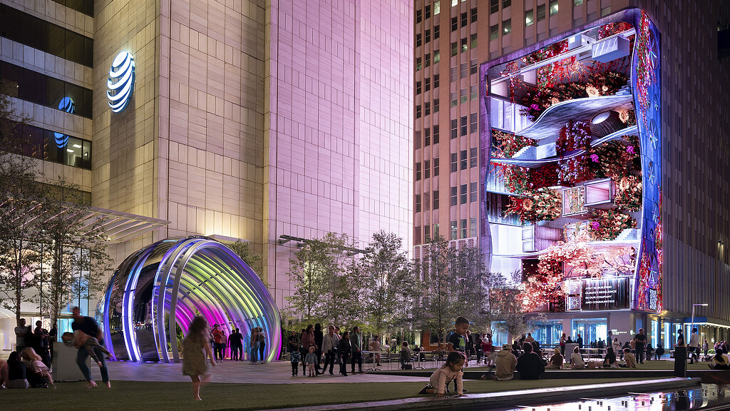 A group of people walking around a city.